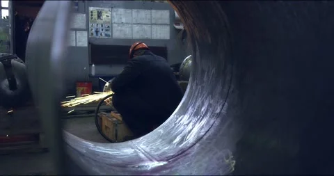 A professional worker in a protective mask works with a grinder in a factory Stock Footage 166027985