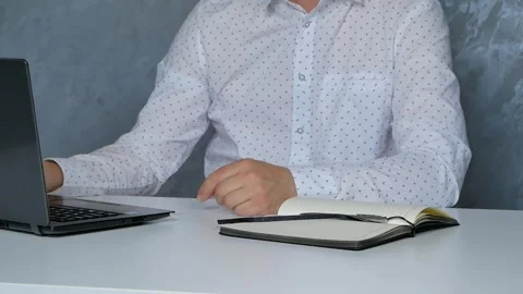 Professional worker puts on glasses and works on a laptop,  Video stock 246404568