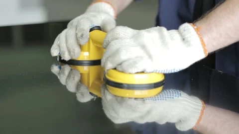 Professional worker puts suctions on large aluminium sheet Stock Footage 138941511