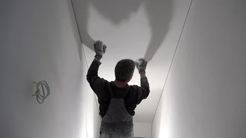 Professional worker with sandpaper in hand prepare wall surface for painting Stock Footage 117154852