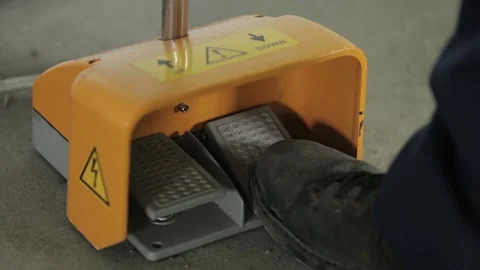 Professional worker steps on plastic factory machine pedal Stock Footage 138937890