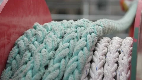 Professional worker stowing white nylon cable on rotating winch in autumn Stock-Footage 165534588