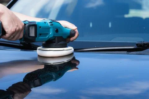 Professional worker uses a high speed electric power buffer tool to careful.. Photos