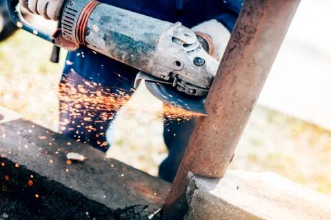 Professional worker using angle grinder mitre saw for cutting bars Stock Photos