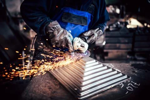 Professional worker using angle grinder for cutting and finishing steel Stock Photos