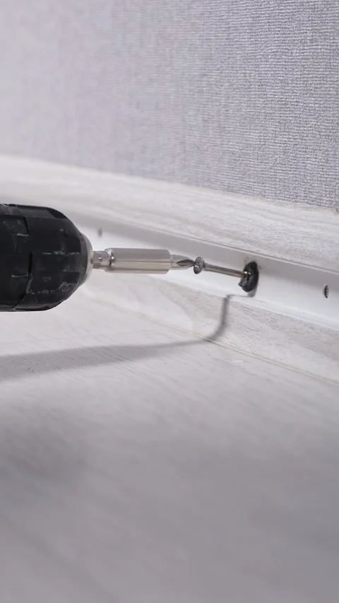 Professional worker using a cordless screwdriver for installing a new plastic 库存影片 342904546