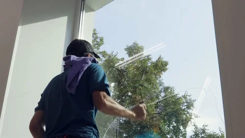 A professional worker washes windows with special products. Cleaning service Stock Footage 163764966