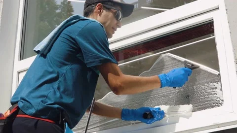 A professional worker washes windows with special products. Cleaning service Stock Footage 165037315