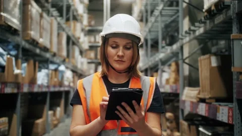 Professional worker wearing hard hat and uniform uses digital gadget, checks Stock Footage 162312652