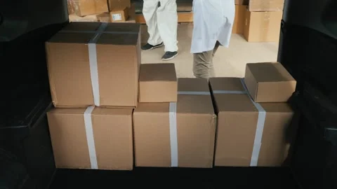 Professional worker in white uniform and protective gloves loading cardboar.. Stock Footage 334542259