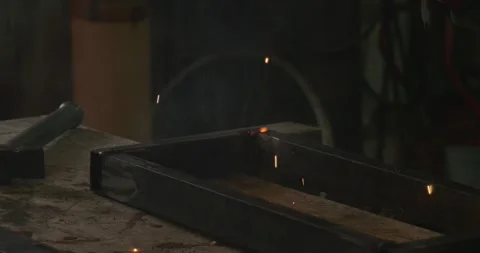 Professional worker in a workshop using a welding machine to connect metal Stock Footage 330780558