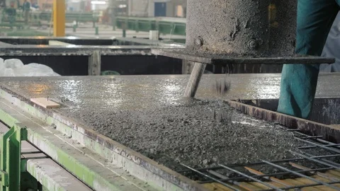 Professional workers fill rebar panel mold with concrete Stock Footage 124608271
