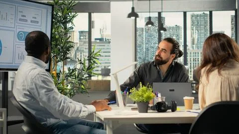 Professional workers focusing on performance metrics and data visualization Stock Photos