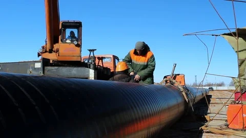 Professional Workers in Helmets Operate with Metal Pipe Stock Footage 77963375
