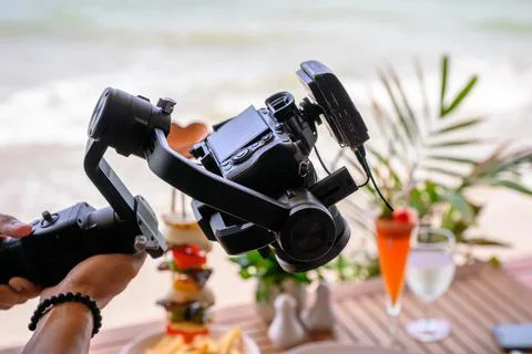Professional working with mirrorless camera and mic wireless on gimbal stabil Stock Photos