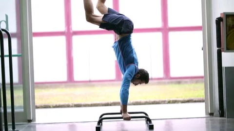 Professional workout guy sequencing from one balance exercise to anothe Stock Footage 119175413