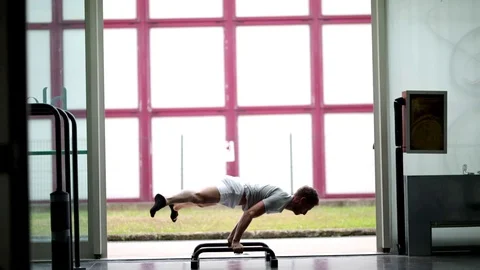 Professional workout guy sequencing from one balance exercise to anothe Stock Footage 119175453