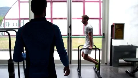 Professional workout guy sequencing from one balance exercise to anothe Stock Footage 119175893