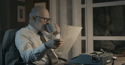 Professional writer checking his work and drinking coffee Stock Footage 151177598