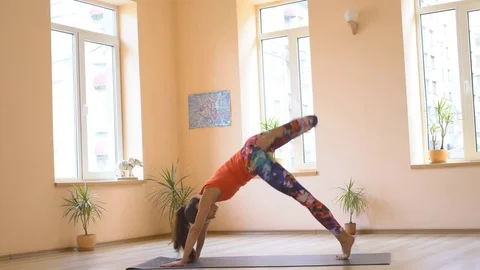 A professional yoga instructor demonstrates a set of healing efforts to Stock Footage 82064385