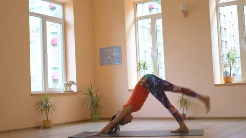 A professional yoga instructor demonstrates a set of healing efforts to Stock Footage 82070360