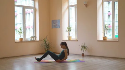 A professional yoga instructor demonstrates a set of healing enhancements for Stock Footage 82168984