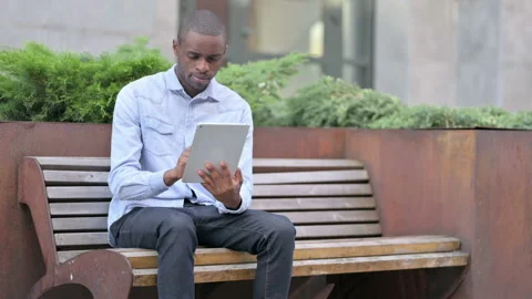 Professional Young African Man Using Tablet Outdoor Stock Footage 136031763