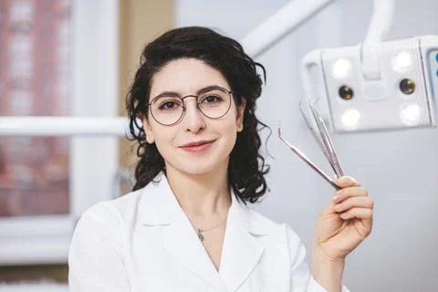 Professional young dentist posing beside modern equipment in a dental clinic. Фото