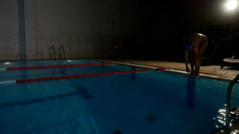 Professional young man swimmer doing butterfly stroke in swimming pool 스톡 동영상 107660436