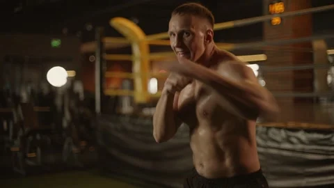 Professional young muscular man is practicing shadow boxing work out in a ring. Stock Footage 269129485