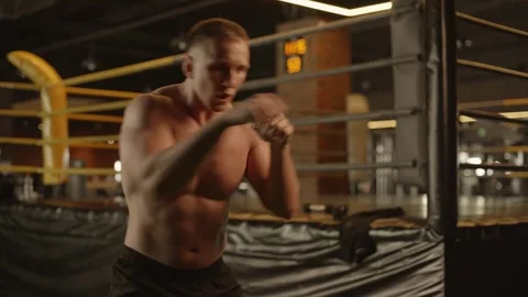 Professional young muscular man is practicing shadow boxing work out in a ring. Stock Footage 269129509