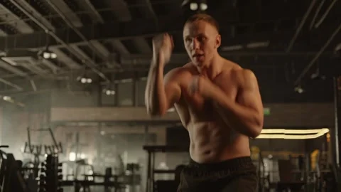 Professional young muscular man is practicing shadow boxing work out in a ring. Stock Footage 269129554