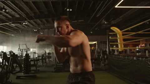 Professional young muscular man is practicing shadow boxing work out in a ring. Stock Footage 269129669