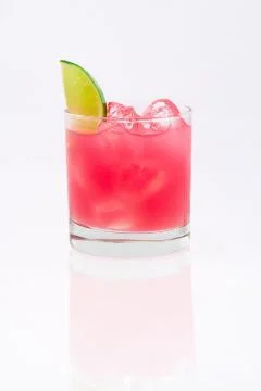 Professionally shot drink with lime on white gradient backdrop. Stock Photos