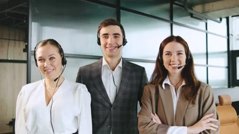 Professionals of call center in a modern office space while providing client Stock Footage 320910989