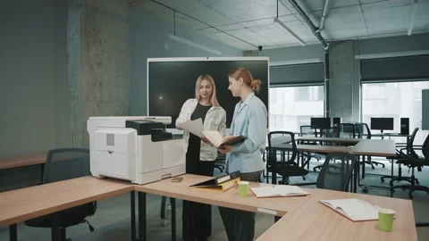 Professionals collaborate in an office space using documents and a printer Video stock 310557422