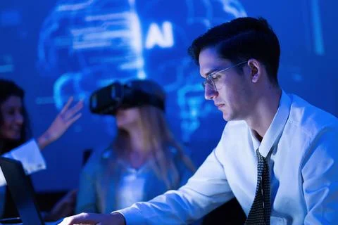 Professionals engaged in virtual reality technology demonstration at a tech.. Stock Photos