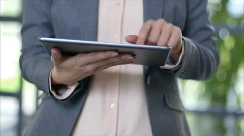 Professional's hands using tablet computer in office Stock Footage 54989828