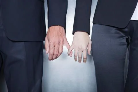 Professionals holding hands, cropped Stock Photos