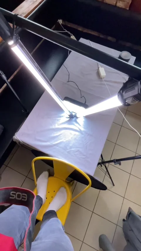 Professionals methodically create props and lighting for images 스톡 동영상 335434956