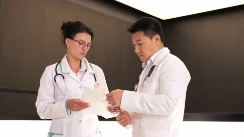 Professionals multinational doctors discussing treatment of the patient. Stock Footage 199806870