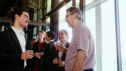 Professionals network at corporate reception, smiling and chatting with drinks Stock Footage 315675163