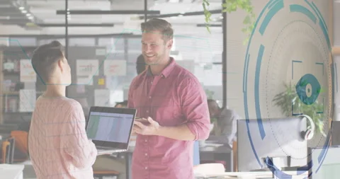 Professionals presenting spreadsheet data in open-plan office, displaying Stock Footage 307550316