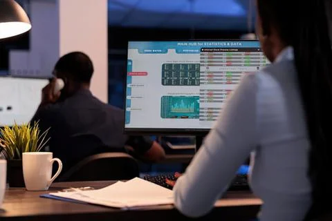 Professionals working with stock market data on computer Stock Photos
