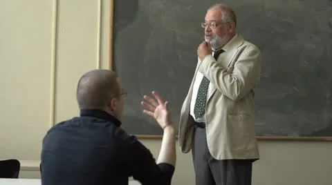 Professor and student talking in a classroom, wide shot Stock Footage 11129513