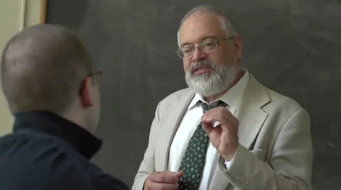 Professor and student talking in a classroom Stock Footage 11129531