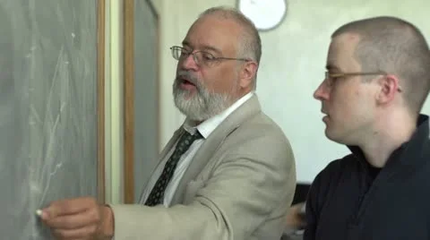 Professor and student working at the chalkboard Stock Footage 11129568