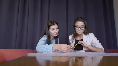 The professor of architecture checks the final project of her student in her Stock Footage 83114806