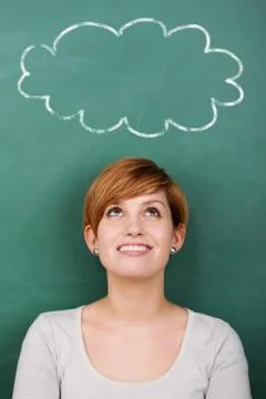 Professor looking at thought bubble on chalkboard Stock Photos