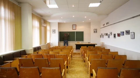 Professor (with model release) beginning to write formula on blackboard Stock Footage 69988462